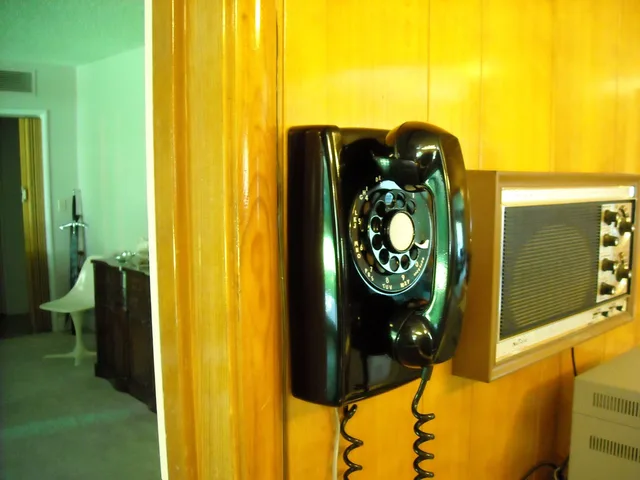 Western Electric model 554 wall phone. Derived from model 500 desk phone and uses same internal components, dial and G series handset. This unit dated 1959. Comparing desk phones with softphone setups